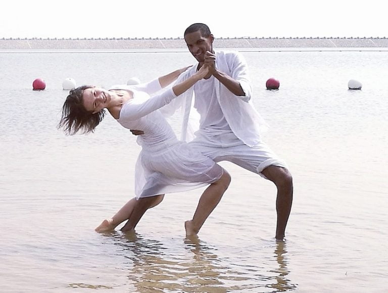 Salsa dance partners holding each other